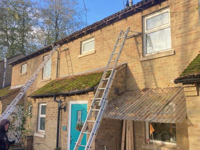 Roofer replacing guttering in Cambridge