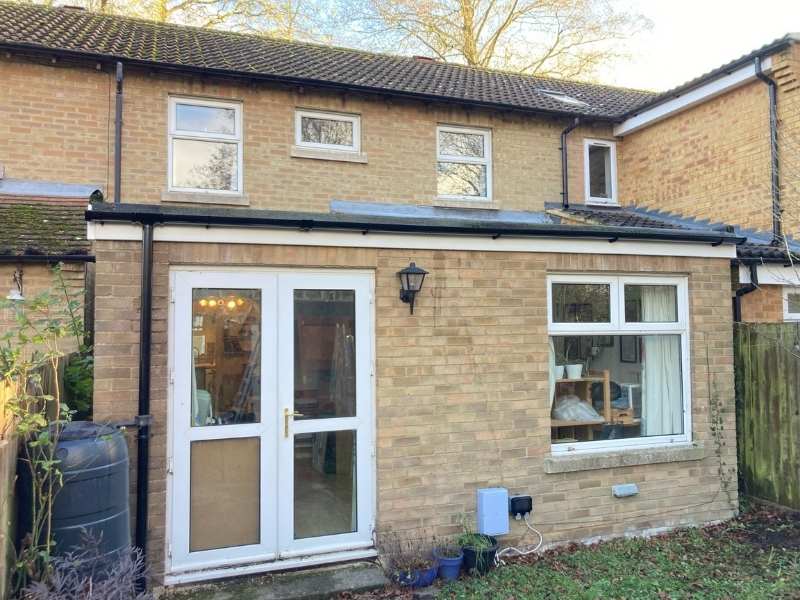Roofer replacing guttering in Cambridge
